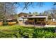Spacious backyard featuring a covered patio, lush lawn, privacy fence, and solar panels at 7590 E Easter Pl, Centennial, CO 80112