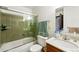 Bathroom featuring a shower-over-tub combo and integrated vanity with a bowl sink at 7590 E Easter Pl, Centennial, CO 80112