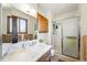 Bright bathroom featuring a modern vanity, mirrored medicine cabinet, and walk-in shower at 7590 E Easter Pl, Centennial, CO 80112