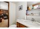 Half-bathroom with a modern vanity featuring a marble-style top at 7590 E Easter Pl, Centennial, CO 80112