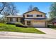 Charming two-story home with a well-manicured lawn and an attached two-car garage at 7590 E Easter Pl, Centennial, CO 80112