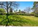 Well-manicured front yard with mature trees and lush green lawn at 7590 E Easter Pl, Centennial, CO 80112