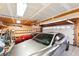 Spacious two-car garage with ample storage space and two parked sports cars at 7590 E Easter Pl, Centennial, CO 80112
