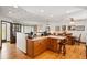 Bright kitchen and dining area with wooden cabinets, a breakfast bar, and open layout at 7590 E Easter Pl, Centennial, CO 80112
