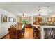 Open-concept kitchen and dining area with hardwood floors and modern lighting at 7590 E Easter Pl, Centennial, CO 80112