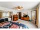 Spacious main bedroom featuring a ceiling fan and sliding mirrored closet doors at 7590 E Easter Pl, Centennial, CO 80112