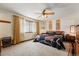 Serene main bedroom with neutral carpet, a ceiling fan, and a cozy atmosphere at 7590 E Easter Pl, Centennial, CO 80112