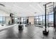 Well-equipped gym featuring modern exercise equipment and floor-to-ceiling windows with city views at 1901 Wazee St # 304, Denver, CO 80202