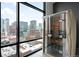 Modern infrared sauna with a view of the downtown buildings through expansive windows at 1901 Wazee St # 304, Denver, CO 80202
