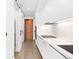 Sleek modern kitchen with white cabinets and stainless steel appliances with wood floors at 1901 Wazee St # 304, Denver, CO 80202