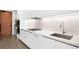 Contemporary kitchen with white countertops, cabinets, and stainless steel fixtures at 1901 Wazee St # 304, Denver, CO 80202