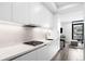 Modern open-concept kitchen with sleek white cabinets and stainless steel appliances at 1901 Wazee St # 304, Denver, CO 80202