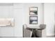 A well-lit kitchenette features white cabinets, silver faucet and table for two with modern art on the wall at 1901 Wazee St # 304, Denver, CO 80202