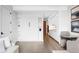 Open-concept living area with white Murphy bed, light wood floors and view of the kitchenette at 1901 Wazee St # 304, Denver, CO 80202