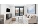 Cozy living room features a sofa, soft rug, view of the city and an entertainment center at 1901 Wazee St # 304, Denver, CO 80202