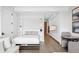 Murphy bed extended, showing built-in shelving, light floors, kitchenette and doorway in the background at 1901 Wazee St # 304, Denver, CO 80202
