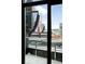 An interior view through a window showcases the rooftop deck overlooking downtown buildings at 1901 Wazee St # 304, Denver, CO 80202