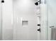 A glass-enclosed shower featuring white subway tile and matte black fixtures gives a modern look at 1901 Wazee St # 304, Denver, CO 80202