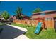 Large backyard with a wood fence, a play structure, a grill and a spacious lawn at 20445 Mitchell Pl, Denver, CO 80249