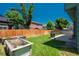 Spacious backyard with green lawn, raised garden beds, grill, and a wood fence at 20445 Mitchell Pl, Denver, CO 80249