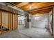 Unfinished basement with exposed beams, concrete floor, and visible utilities at 20445 Mitchell Pl, Denver, CO 80249