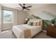 Inviting bedroom featuring white bedding, natural light, colorful wall art, and modern furnishings, creating a warm and inviting space at 20445 Mitchell Pl, Denver, CO 80249