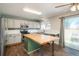 Eat-in kitchen featuring stainless steel appliances, granite countertops, and wood-look flooring at 20445 Mitchell Pl, Denver, CO 80249