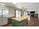 Bright, open kitchen with an island, wood floors, stainless steel appliances, and a view of the backyard at 20445 Mitchell Pl, Denver, CO 80249