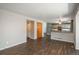 Bright and airy living area connecting to the kitchen, showcasing wood-look flooring and neutral decor at 20445 Mitchell Pl, Denver, CO 80249