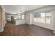 Open concept layout connecting the living room and kitchen with wood-look floors and plenty of natural light at 20445 Mitchell Pl, Denver, CO 80249