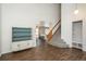 Open floor plan featuring hardwood floors, vaulted ceilings, and neutral paint at 20445 Mitchell Pl, Denver, CO 80249