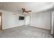 Spacious living room featuring plush carpeting, ceiling fan, and open archway at 20445 Mitchell Pl, Denver, CO 80249