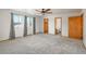 Spacious primary bedroom with neutral carpeting and a ceiling fan at 20445 Mitchell Pl, Denver, CO 80249