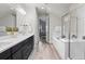 Bright bathroom featuring double vanities, a soaking tub, and a glass shower at 1867 W 137Th Ln, Broomfield, CO 80023