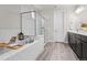 Luxurious bathroom with a soaking tub, glass-enclosed shower, and modern fixtures at 1867 W 137Th Ln, Broomfield, CO 80023