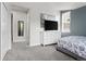 This bedroom includes carpeted floors, a television on a bureau, and large windows at 1867 W 137Th Ln, Broomfield, CO 80023