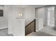 Well-lit hallway with wooden staircase and neutral decor at 1867 W 137Th Ln, Broomfield, CO 80023