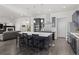Modern kitchen featuring a large island with seating, stainless steel appliances, and seamless flow to the living area at 1867 W 137Th Ln, Broomfield, CO 80023