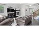 Comfortable living room with a fireplace, a stylish clock, and an open floor plan at 1867 W 137Th Ln, Broomfield, CO 80023