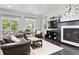 Cozy living room with plush seating, fireplace, and large windows offering natural light and a view of the outdoors at 1867 W 137Th Ln, Broomfield, CO 80023
