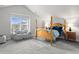 Spacious main bedroom with a four-poster bed, large window, and comfortable seating area at 1867 W 137Th Ln, Broomfield, CO 80023
