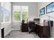 Bright home office with a large window, dark wood desk and gray carpet at 1867 W 137Th Ln, Broomfield, CO 80023