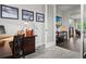 Home office includes a wood desk, carpeted floors, and photos hanging on the wall at 1867 W 137Th Ln, Broomfield, CO 80023