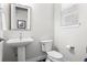 Stylish powder room features a pedestal sink, elegant fixtures, and modern decor at 1867 W 137Th Ln, Broomfield, CO 80023