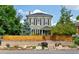 Charming two-story home with a landscaped front yard and a wooden fence, perfect for curb appeal at 2098 N Clarkson St, Denver, CO 80205