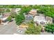 Aerial view showcasing a home's lush landscaping, proximity to neighboring houses, and neighborhood's tree-lined streets at 2098 N Clarkson St, Denver, CO 80205