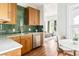 Charming kitchen with wood cabinets, green tile backsplash, and bright breakfast nook at 2098 N Clarkson St, Denver, CO 80205