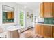 Bright kitchen featuring wooden cabinets and an adjacent dining area at 2098 N Clarkson St, Denver, CO 80205