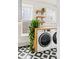 Charming laundry room with modern washer and dryer, patterned tile floor, and natural light from two windows at 2098 N Clarkson St, Denver, CO 80205