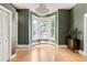 Living room with bay window, hardwood floors, and modern lighting at 2098 N Clarkson St, Denver, CO 80205